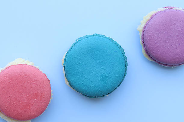 Closeup and Top view colorful macarons on a blue background. dessert cookies are both delightful and eye catching.