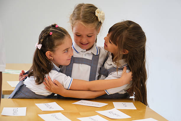 Three female students are embracing each other, showing their friendship and unity
