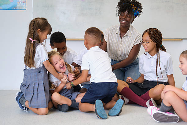 istock Elementary school students and their teacher playing together in the classroom 2229343605