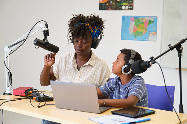 istock Teacher and student recording podcast in classroom 2229343706