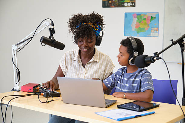 istock Teacher and student recording podcast in classroom 2229343998
