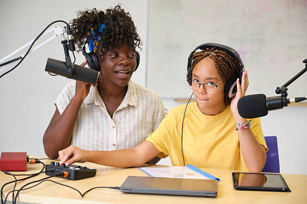 istock Two young female podcasters recording audio content in a studio 2229344300