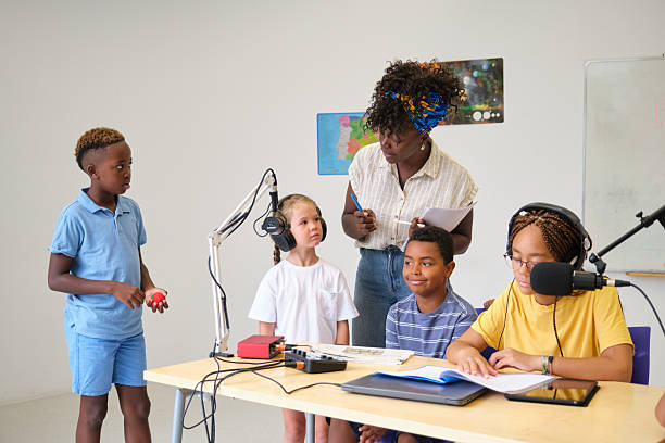 istock Students recording podcast with teacher in classroom 2229344514