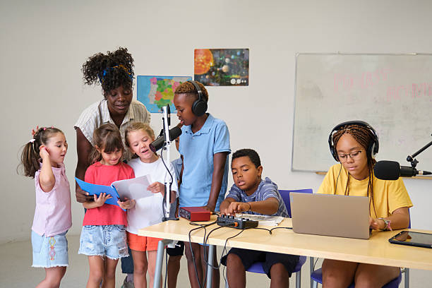 istock Elementary school students recording a podcast with their teacher 2229345327