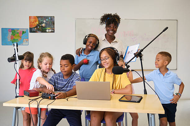 istock Elementary school students recording a podcast with their teacher 2229345418