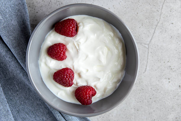 istock Gray ceramic bowl and natural yogurt with berries on the stone marble table. 2229346902