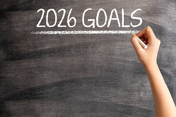 istock 2026 Goals on Blackboard with Woman Hand 2229347038