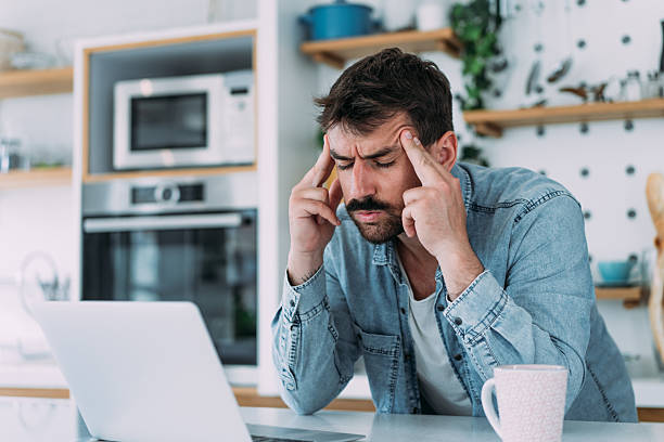 istock Stressed businessman having headache while working on laptop at home. 2229347202