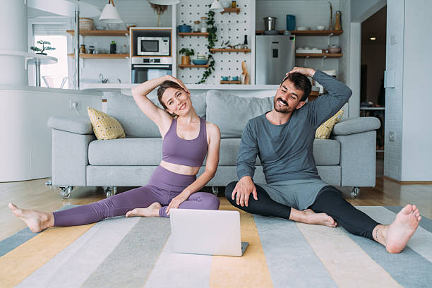 istock Couple exercising together at home. 2229347245