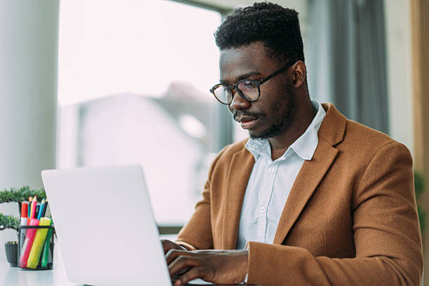 istock Successful businessman in modern office working on laptop. 2229347258
