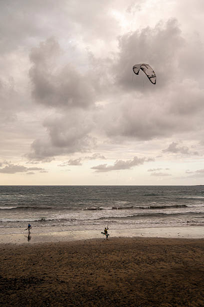 istock A kite is flying in the sky above a beach 2229350616