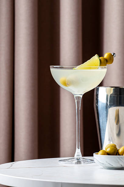 istock Refreshing Mexican martini served in a cocktail glass with lime and olives on a chic table setting 2229350726