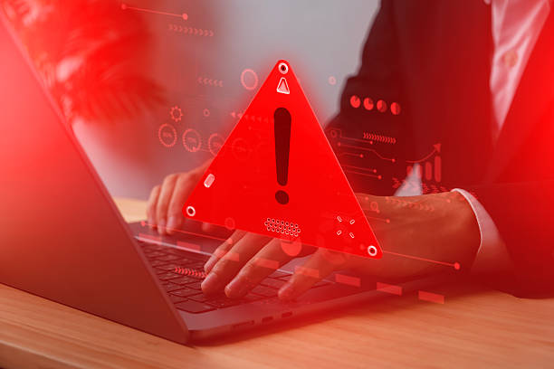 istock cyber security risk. Businessman typing on laptop with red warning alert sign, hacking threat, malware attack, and online data breach in digital business environment. 2229352081