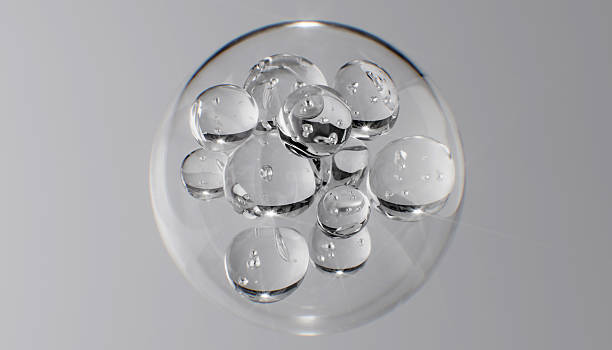 istock Abstract cosmetic background with glass spheres and bubbles inside a larger orb. Hyaluronic acid, serum, or the molecular structure of a hydrating essence 3d rendering science concept. 2229354264