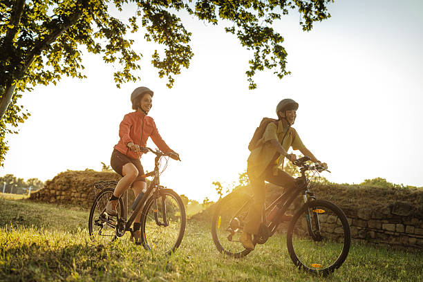 istock Two friends cycling outdoors in nature during a sunny day 2229356238