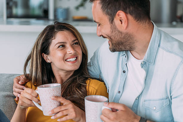 istock Lovely young couple drinking coffee at home. 2229356633
