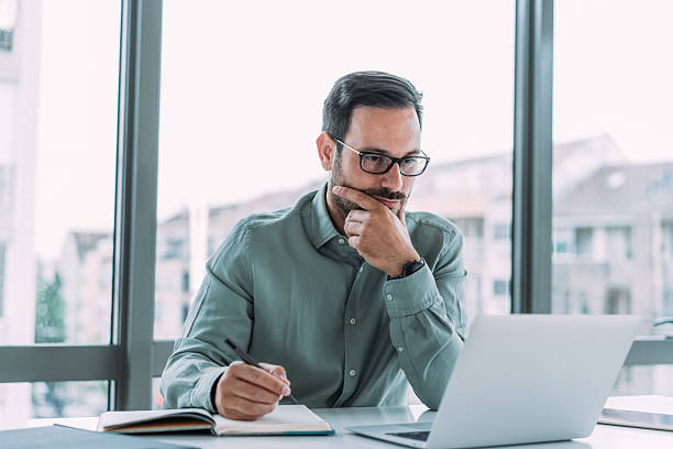 istock Stressed businessman working on laptop in the office. 2229356669