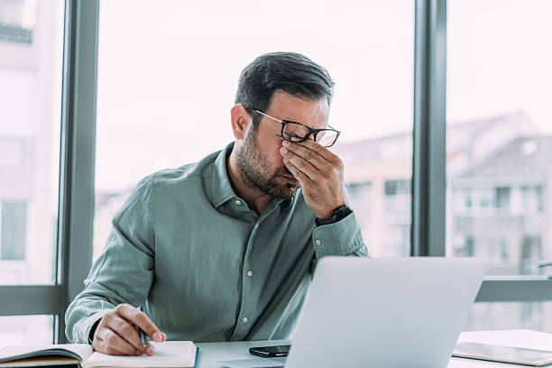 istock Stressed businessman having headache while working on laptop in the office. 2229356680