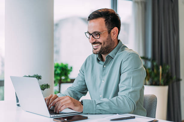 istock Successful businessman in modern office working on laptop. 2229356703