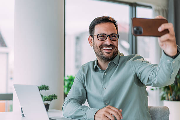 istock Businessman using smartphone for video call in the office. 2229356707
