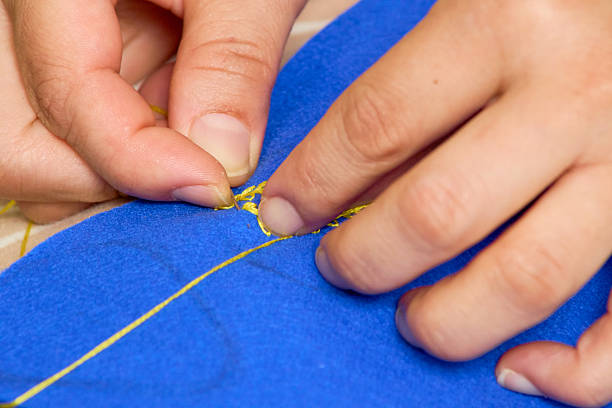 Embroidering a leaf motif.