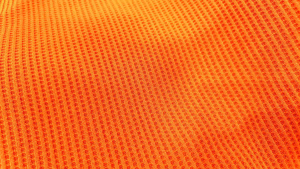 istock Close-up view of an orange textured fabric. 2229360095