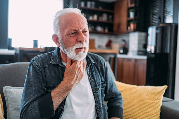 istock Senior man feeling pain in his throat. 2229361159