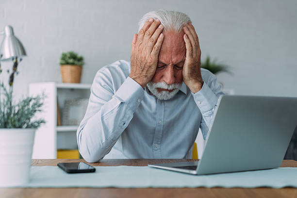 istock Stressed businessman having headache while working on laptop in the office. 2229361177