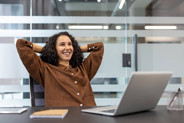 istock Successful businesswoman well done, successfully completed current project. Office worker with hands behind head resting and relaxing, enjoying results of achievement 2229365574