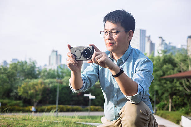 istock An Asian businessman sitting on the steps outdoors using timing 2229368556
