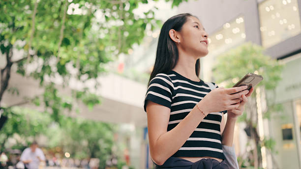 Travelers using travel apps for real-time communication with accommodation hosts, tour operators, and local guides. Capture them text messaging, sharing locations