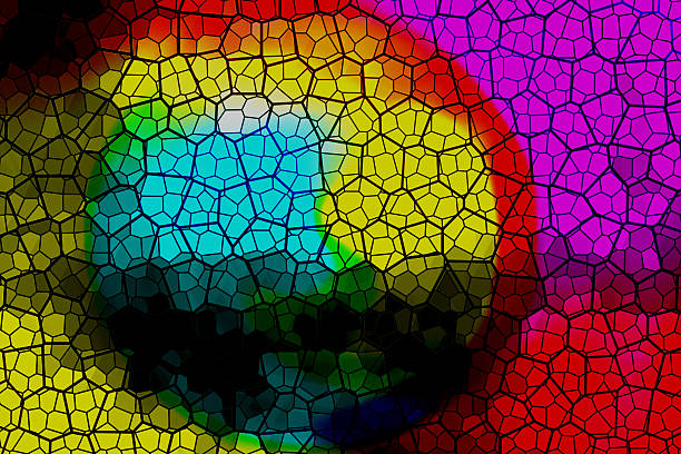Vibrant colors shine through a stained glass mosaic, creating an abstract pattern with a network of dark lines