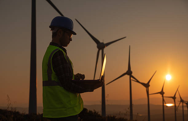 istock Portrait of Engineer Using Laptop at Wind Farm During Sunset Symbolizing Sustainability and Artificial Intelligence in Renewable Energy 2229378367
