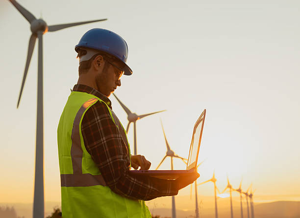 istock Portrait of Engineer Using Laptop at Wind Farm During Sunset Symbolizing Sustainability and Artificial Intelligence in Renewable Energy 2229378377