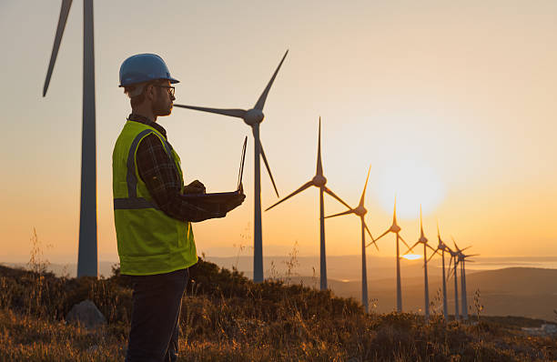istock Portrait of Engineer Using Laptop at Wind Farm During Sunset Symbolizing Sustainability and Artificial Intelligence in Renewable Energy 2229378391