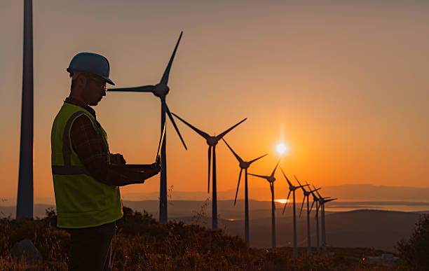 istock Portrait of Engineer Using Laptop at Wind Farm During Sunset Symbolizing Sustainability and Artificial Intelligence in Renewable Energy 2229378398