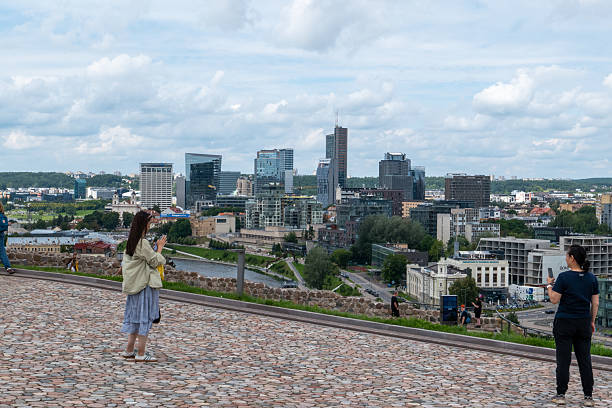 A stunning image of Vilnius, Lithuania, featuring the blend of historic Old Town's charming architecture with contemporary buildings. Capturing the vibrant atmosphere of the Lithuanian capital, this photo highlights cobblestone streets, medieval churches, and modern city elements, ideal for editorial content on travel, culture, urban development, or European destinations.