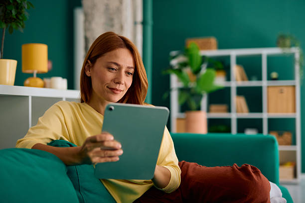 istock Woman relaxing on the sofa using a digital tablet 2229380464