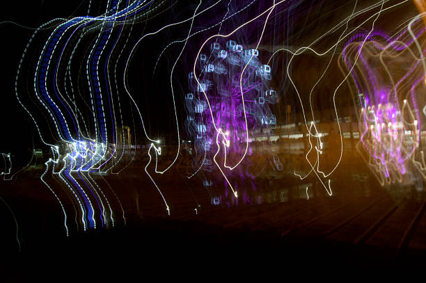 istock Moving lights on a Ferris wheel at night 2229382369