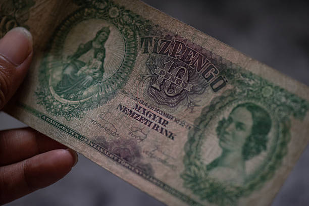 istock Closeup view of a hand holding a ten pengo banknote. 2229384202