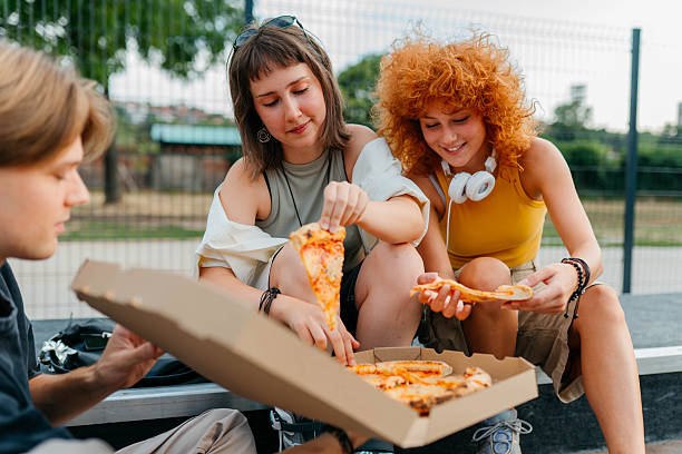 istock Eating pizza in the park 2229387562