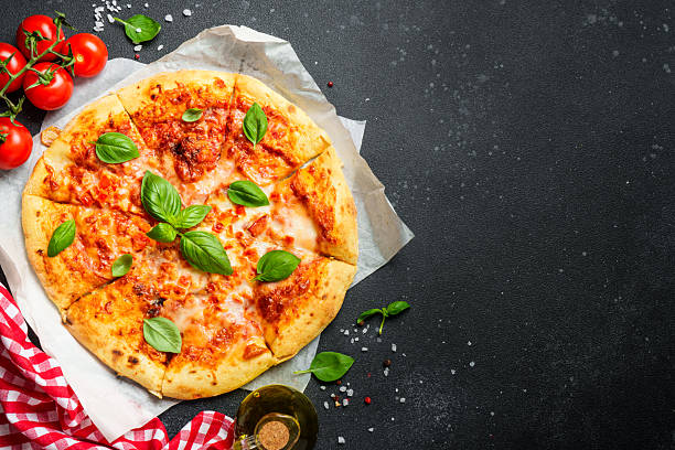 istock Pizza margarita on black background with ingredients for cooking. 2229391622