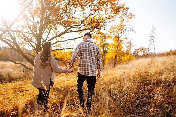 istock Two beautiful people enjoying time together in an autumn forest. 2229392481