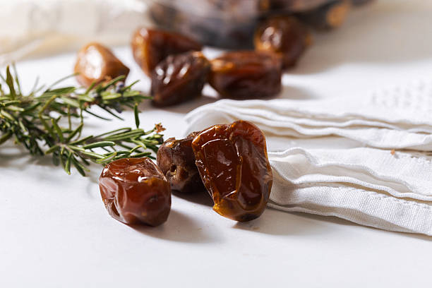 istock Fresh Organic Dates with Rosemary on White Background 2229393776