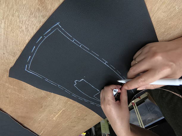 istock Cutting and preparing black leather or synthetic material for custom car interior 2229396989