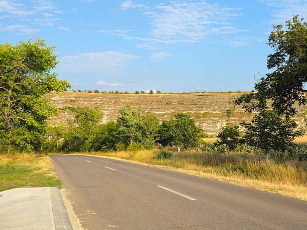 istock A road with trees and hills in the background 2229399155