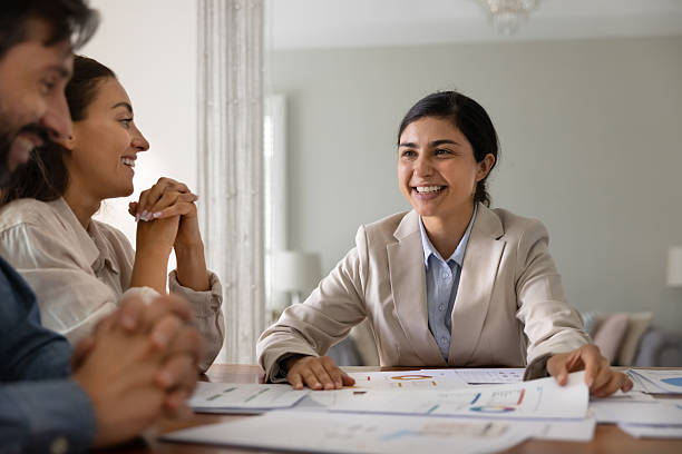 istock Advisor and couple reviewing financial data displaying in charts 2229400766