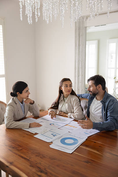 Young Indian female professional advisor consulting couple