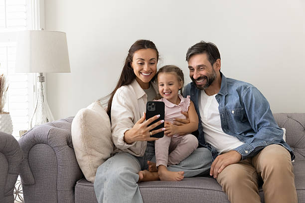 istock Family with little cute daughter using modern smartphone 2229403427