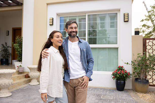 istock Happy couple stands affectionately together outside their modern home 2229403905
